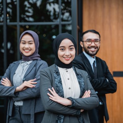 beautiful muslim businesswoman leader as she standing in front of her team smiling proudly to camera